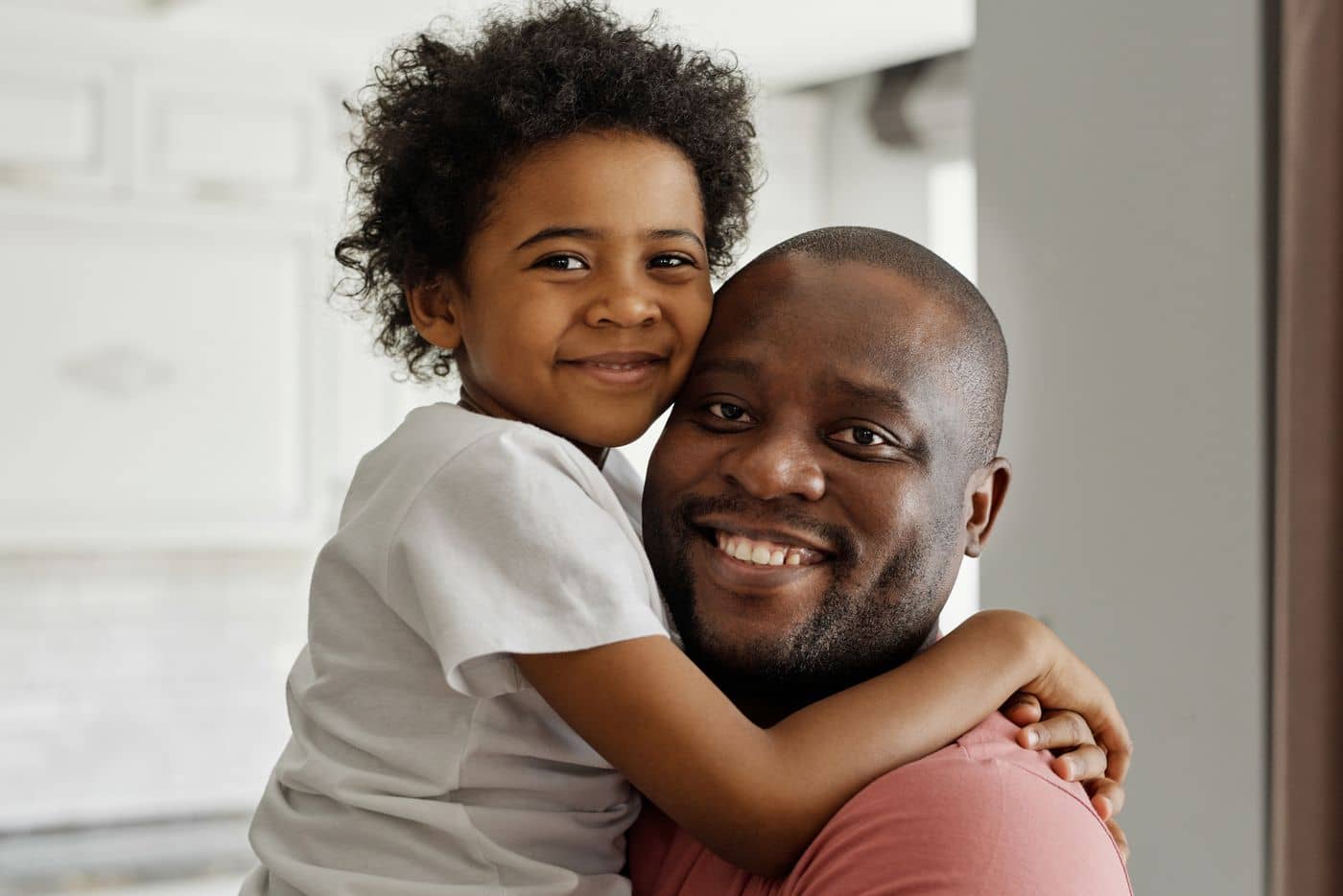 Father and son hugging and smiling