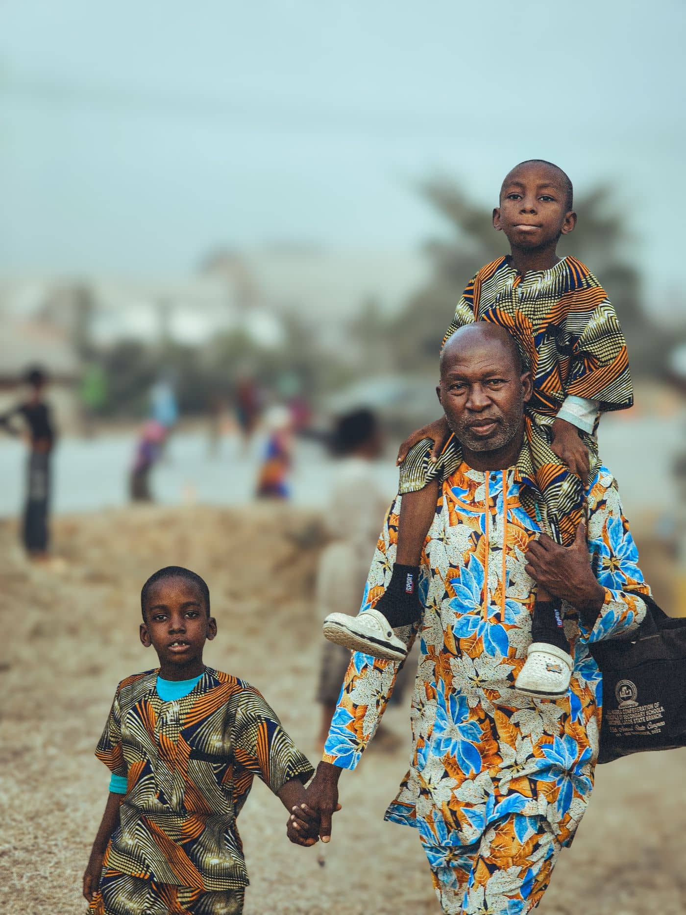 Grandfather carrying his grandchildren